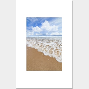 Waves sand beach and clouds sunny day Posters and Art